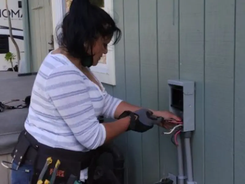 Licensed electrician wiring an exterior subpanel in East Rutherford